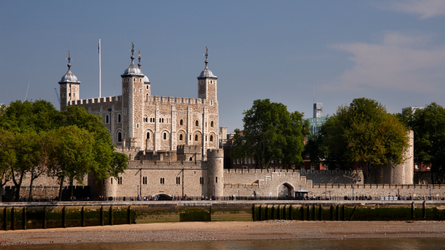 The Tower of London seen from the river, on a sunny day and clear sky in the backgound.
