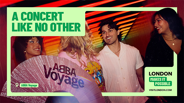 Two people stand with a sparkling abba fan at the abba voyage experience in london