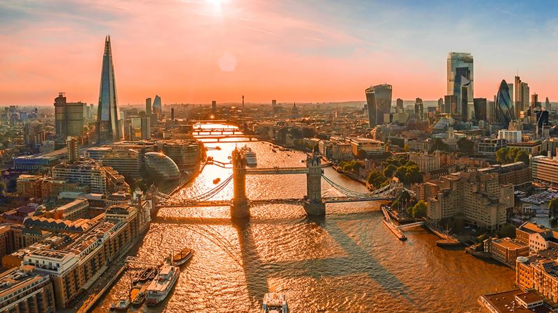 The London skyline at sunrise with views of Tower Bridge, the Shard and the skyscrapers in the City of London.