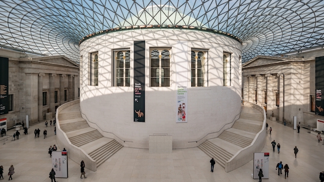 People walking through the Great Court at the British Museum in London on a sunny day