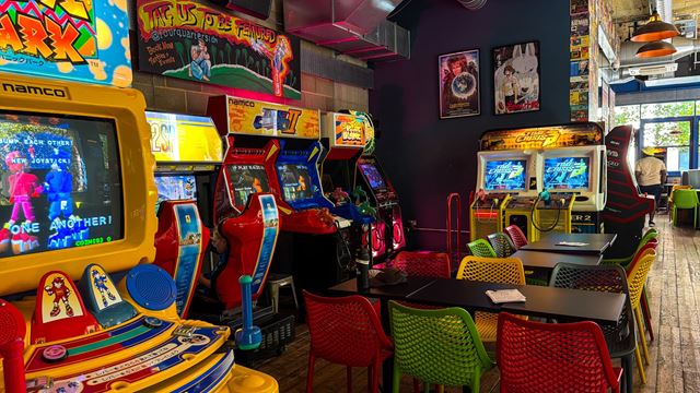 Colourful retro arcade game consoles and seats at Four Quarters' Elephant and Castle venue.