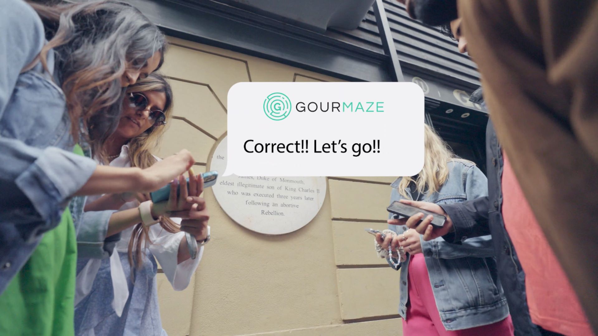 Crack clues, uncover hidden spots and taste your way through London. Image courtesy of Gourmaze. Group using phones to solve clues during an outdoor food treasure hunt experience in London.