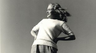 Black and white photograph of Marilyn Monroe looking into the distance.