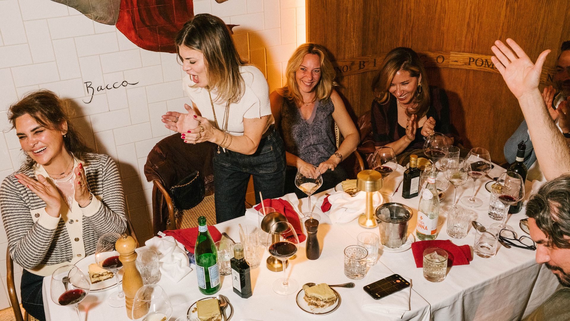 A group of friends enjoy food, drinks and conversation around a table at Vocale in Mayfair.