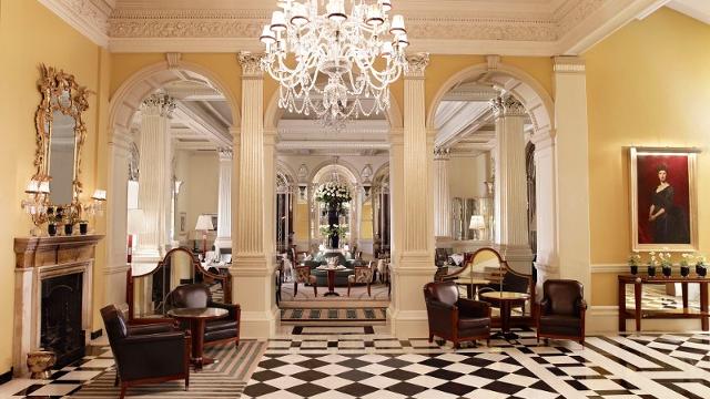 The warmly lit lobby of the luxury claridges hotel in london.