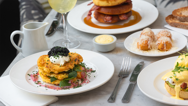Enjoy a selection of tasty brunch dishes including the Avruga caviar, creme fraiche, smoked salmon and latke potato cakes. Credit: Bourne & Hollingsworth. Image courtesy of Bourne & Hollingsworth. A variety of brunch dishes such as potato cakes, eggs benedict and pancakes with bacon and maple syrup