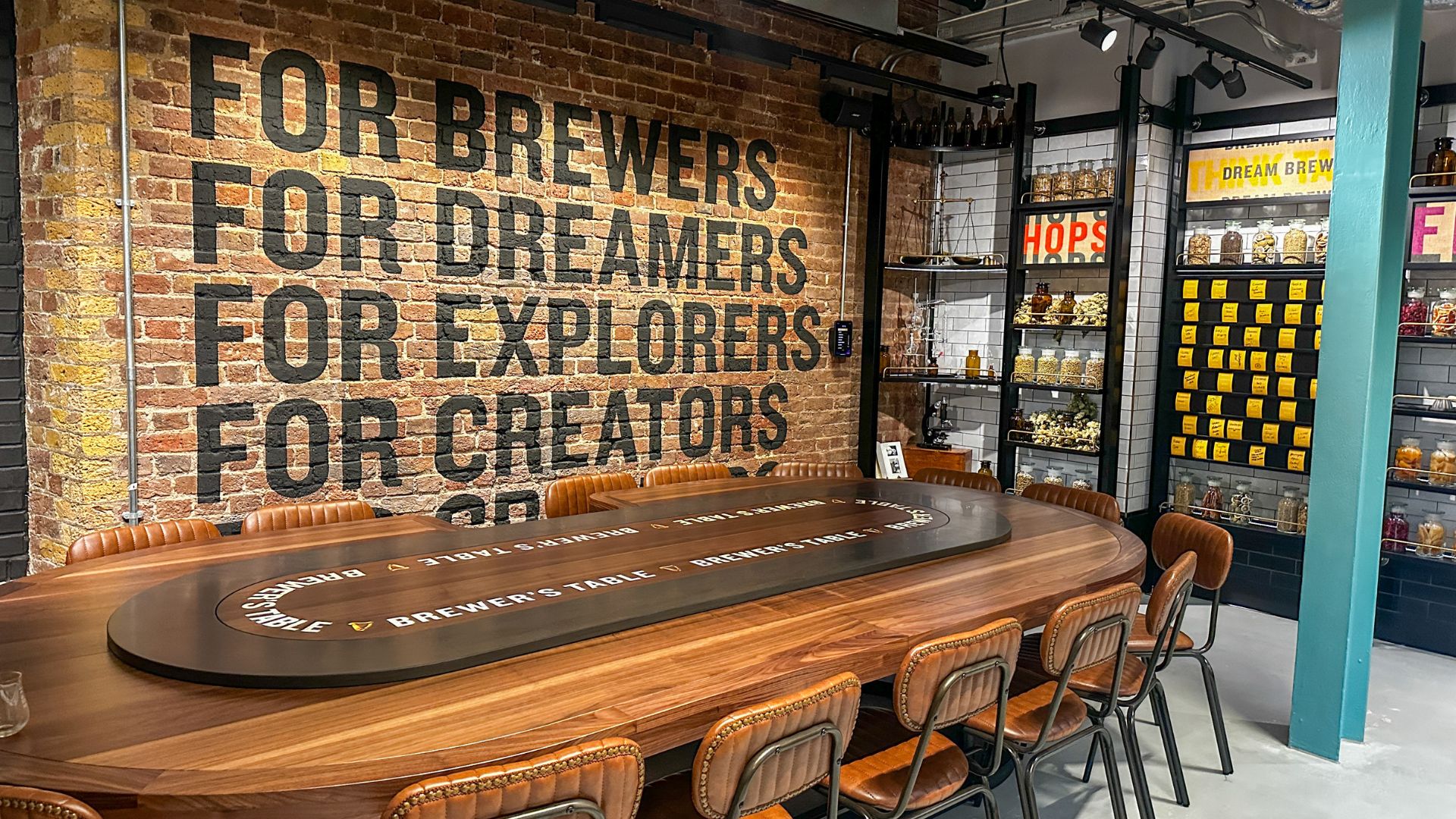 Inside the Guinness Open Gate Brewery London, where brewing heritage meets contemporary design. Image courtesy of Kirstine Spicer. Interior of the Guinness Open Gate Brewery London featuring tasting tables, exposed brickwork and brewing details.