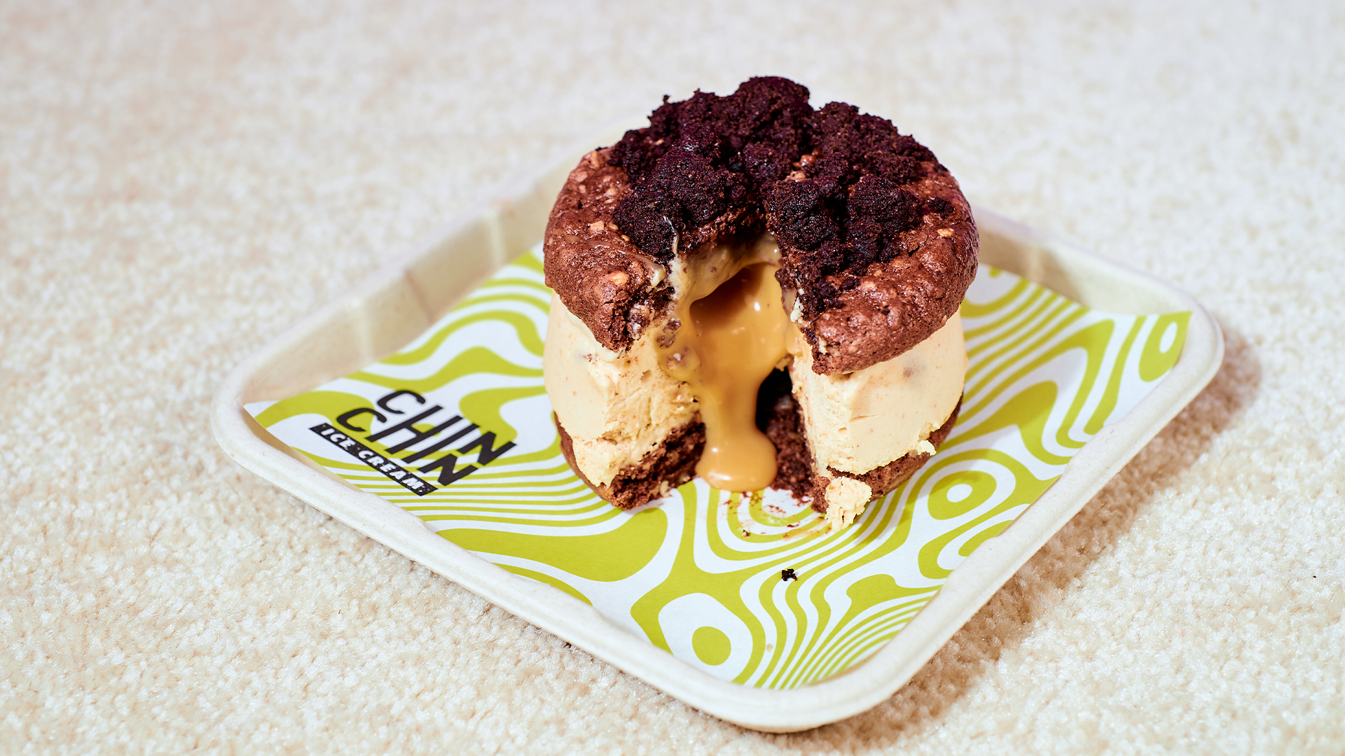 A peanut caramel chewy cookie sandwich placed on a white tray
