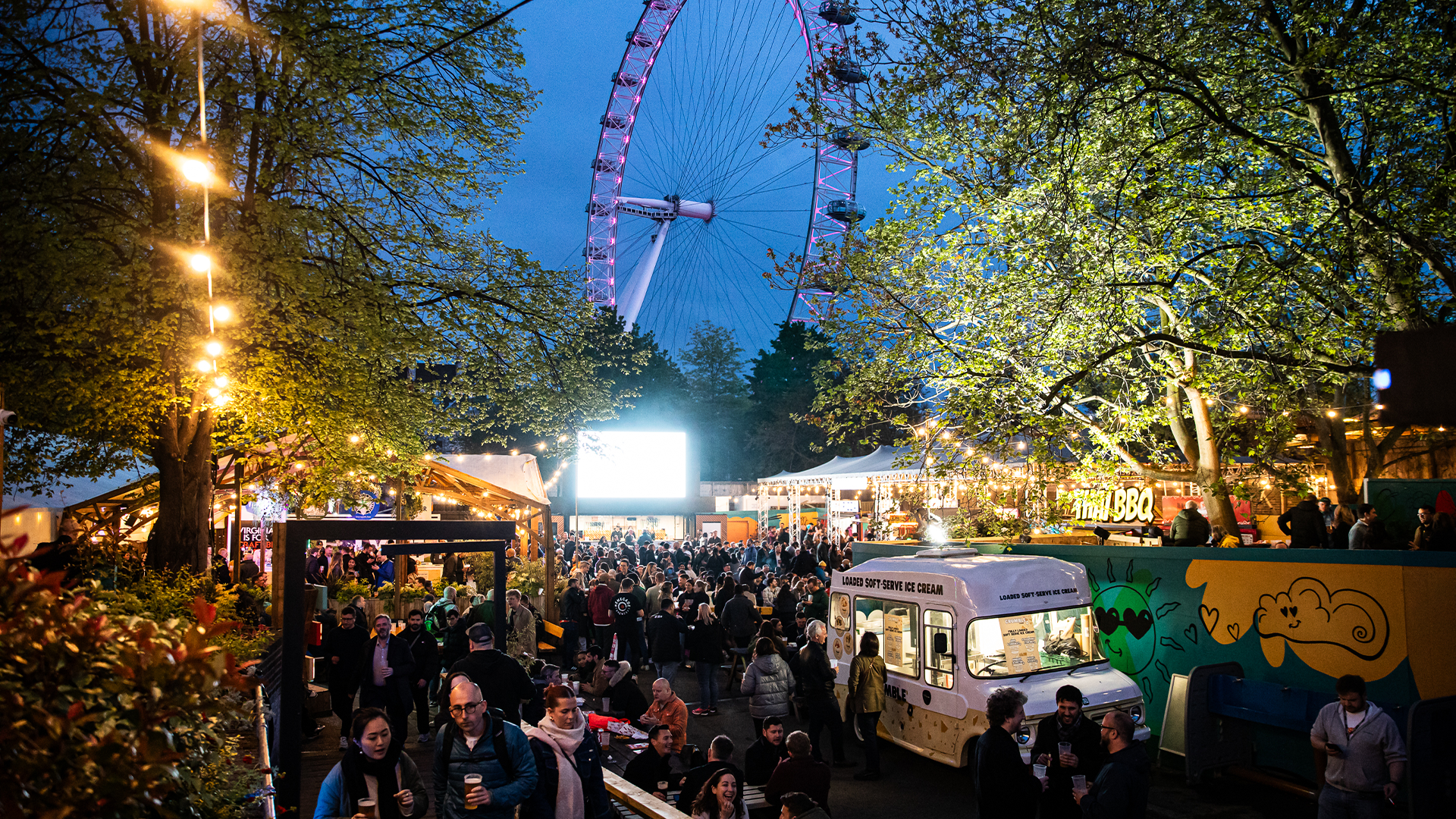 Crowds of people enjoy drinks and street food at Southbank