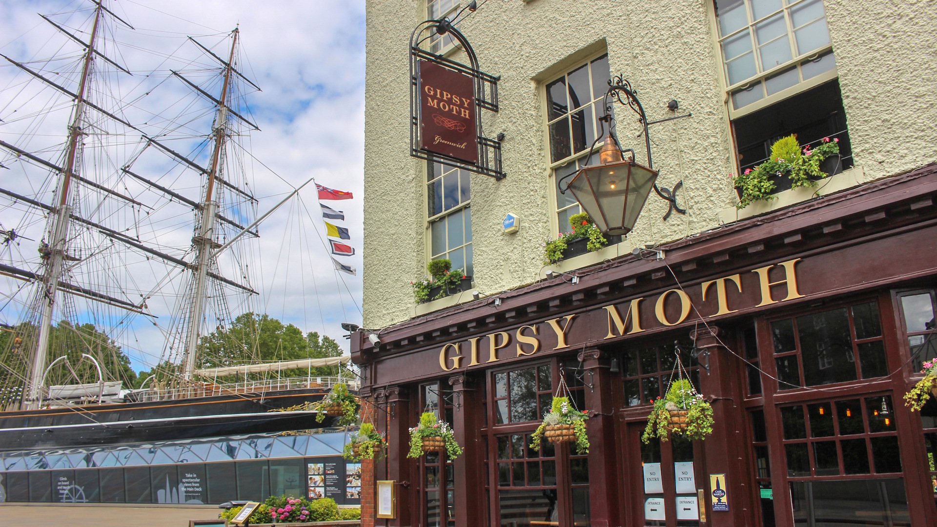 The Gipsy Moth pub facade within view of the famous Cutty Sark in Greenwich.