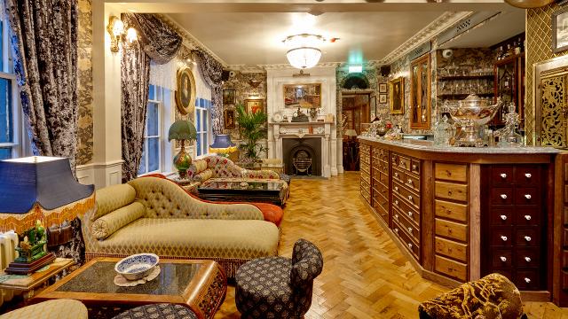 A  london gin parlour with sofas and tables.