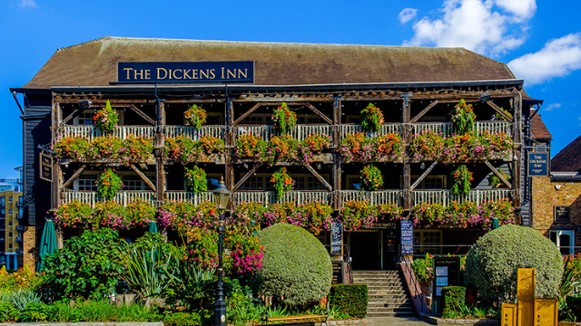 The picturesque Dickens Inn with flowers on all the balconies