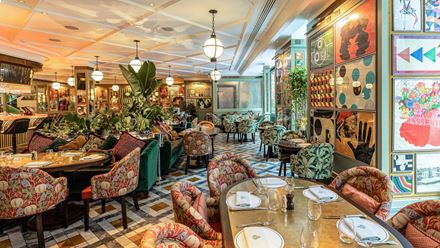 Discover a colourful setting with art adorning the walls at The Ivy Soho Brasserie. Credit: The Ivy Collection. Image courtesy of The Ivy Collection.