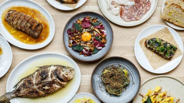 A spread of bright dishes including fish and steak tar tar from Manteca restaurant in London.