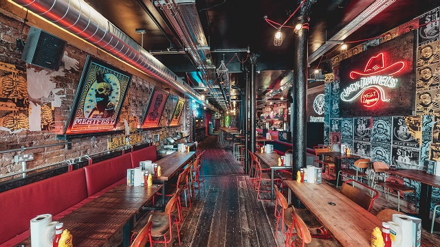 trendy urban bar with stool seating, graffiti art walls and neon signs
