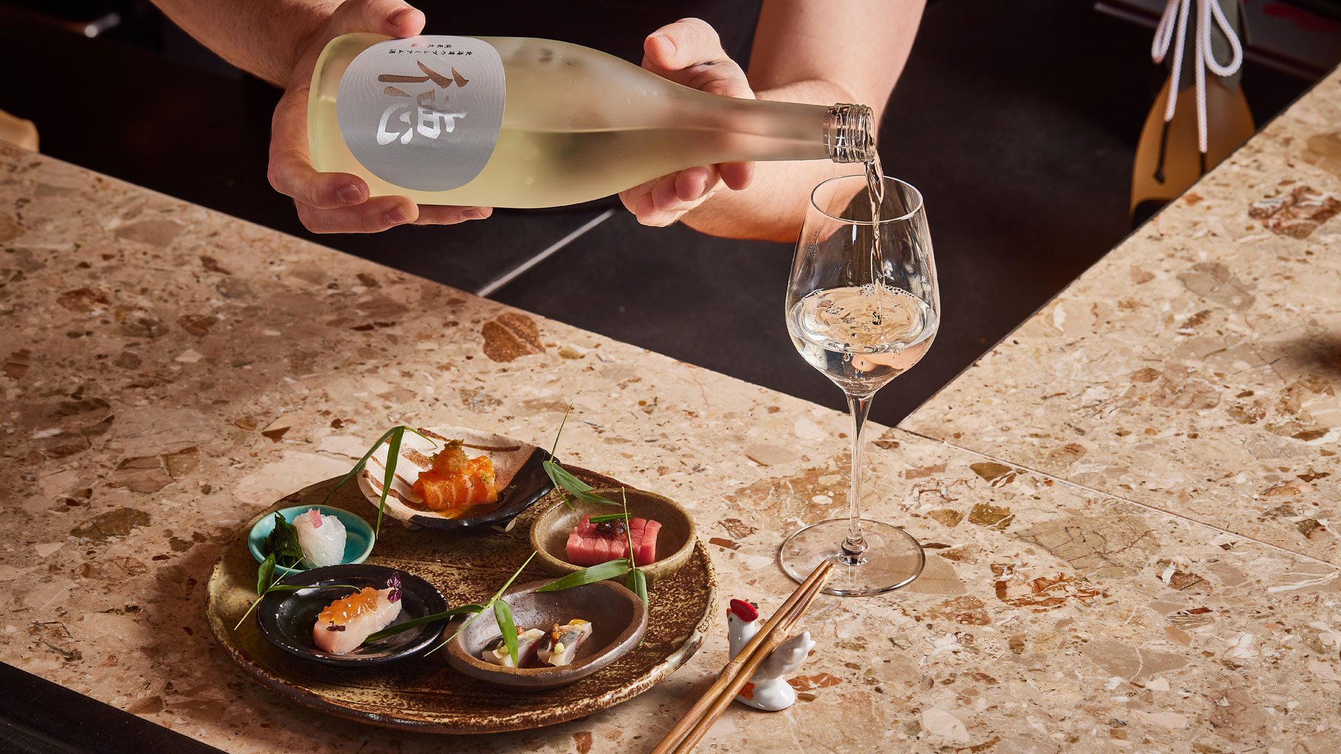 A plate featuring a selection of Japanese tapas is disposed on a counter at Humble Chicken, a Michelin star restaurant in London.