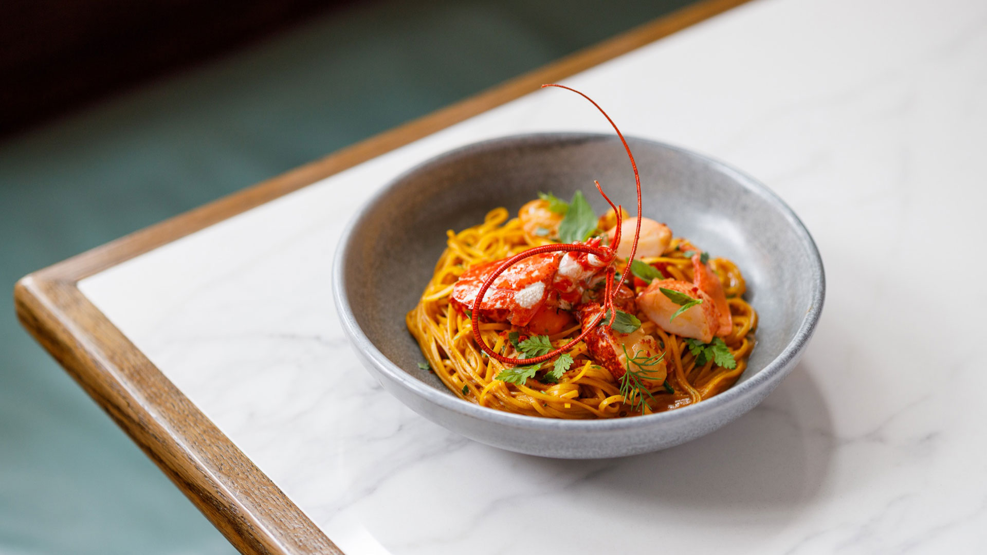 A colourful plate of pasta topped with grilled seafood is served at Michelin starred Italian restaurant Luca.