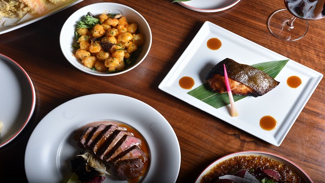 birds eye shot of Japanese small plates presented on a wooden table