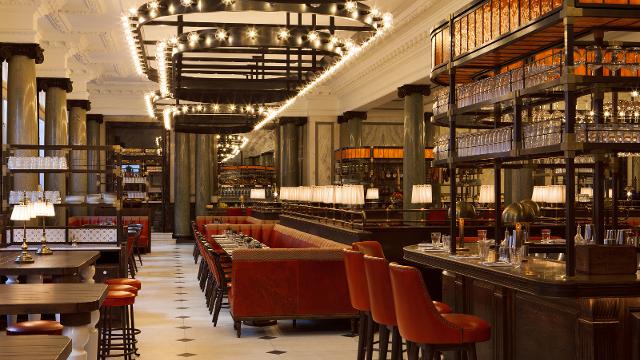 A luxury restaurant with brown leather seats and bright lights.