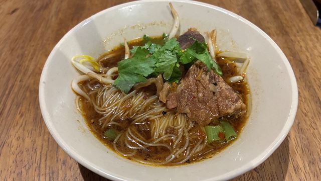A bowl of authentic Thai boat noodles at Sen Sen, featuring beef brisket, broth, vermicelli noodles, bean sprouts and coriander.