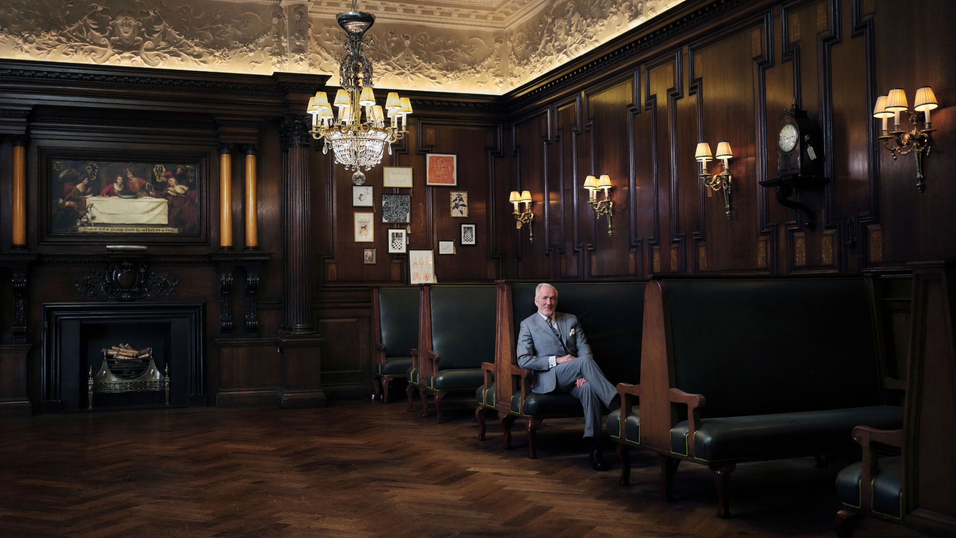 Interior of the Grand Divan at Simpson’s in the Strand, featuring dark wood panelling, chandeliers, high-backed leather seating and historic Edwardian detailing.