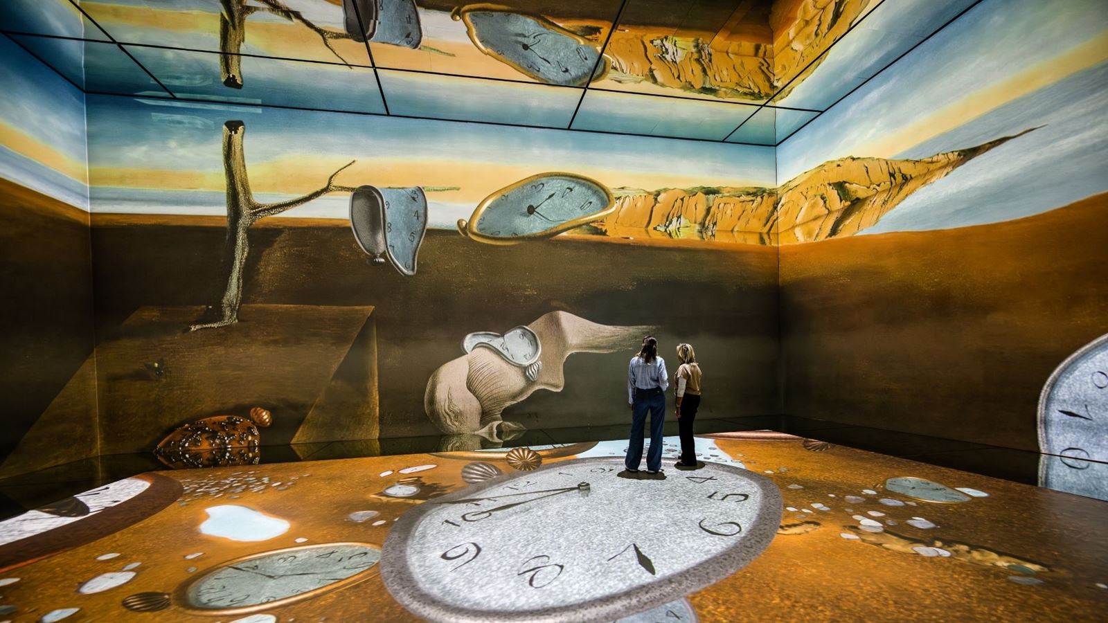 Two women standing in a Salvador Dai painting at FRAMELESS