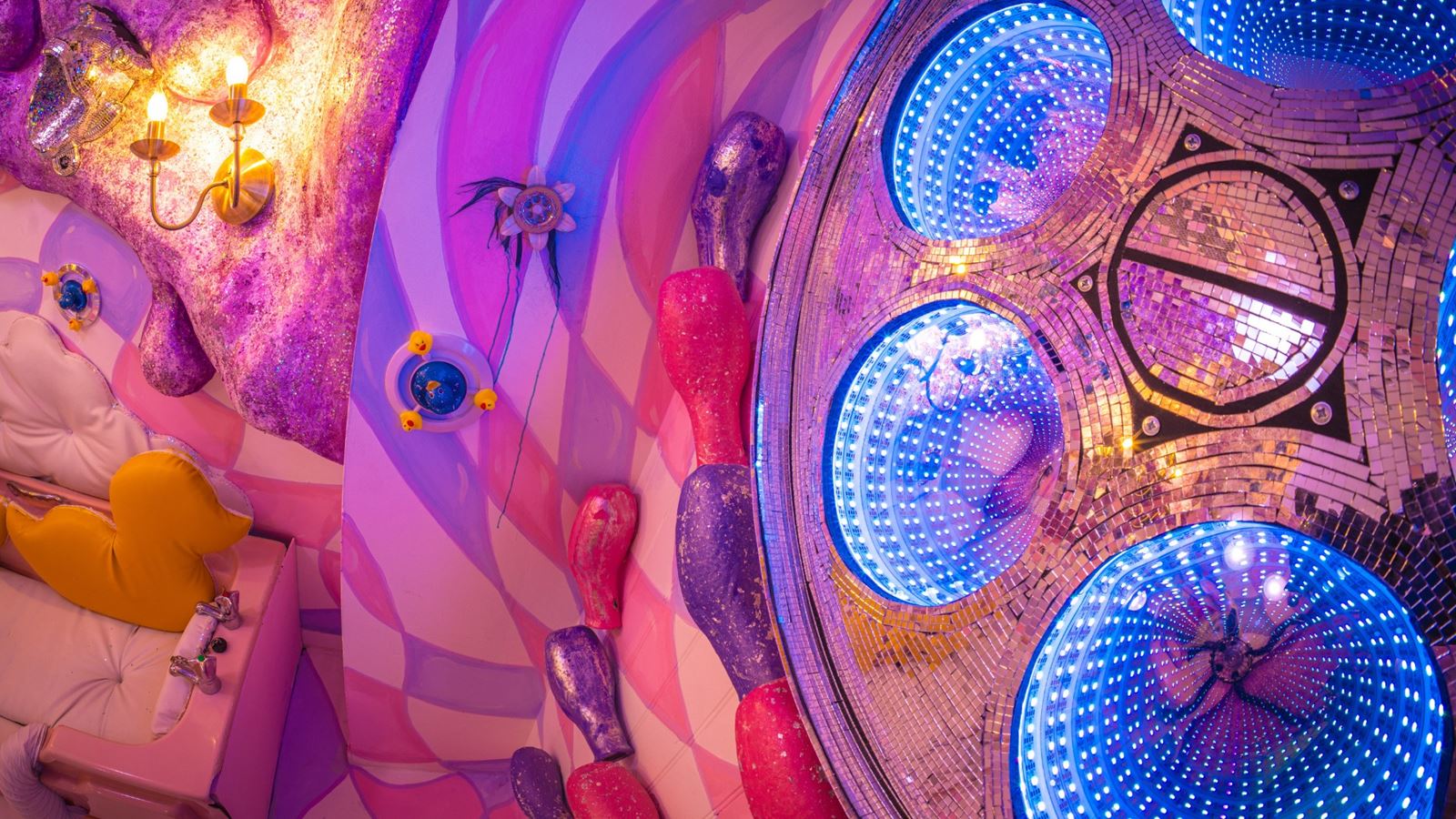 A colourful, vibrant room filled with surreal installations, hidden corners, and mind-bending visuals that is part of the Wake The Tiger Absurd City immersive experience