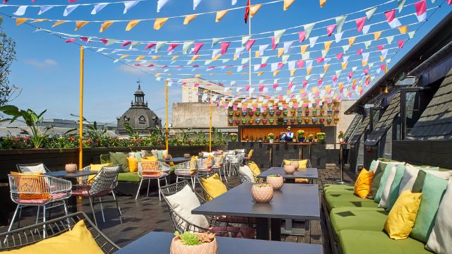 A mixologist makes a cocktail on the rooftop bar of Aqua Nueva in London.