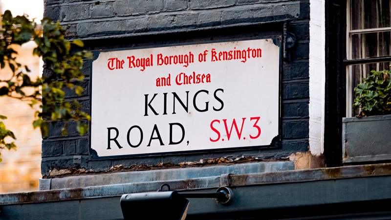 The King's Road sign on a brick wall that reads "The Royal Borough of Kensington and Chelsea Kings Road SW3"