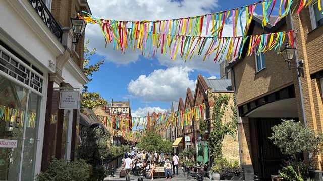 A view along Pavilion Road with colourful bunting and shops on each side of the road.