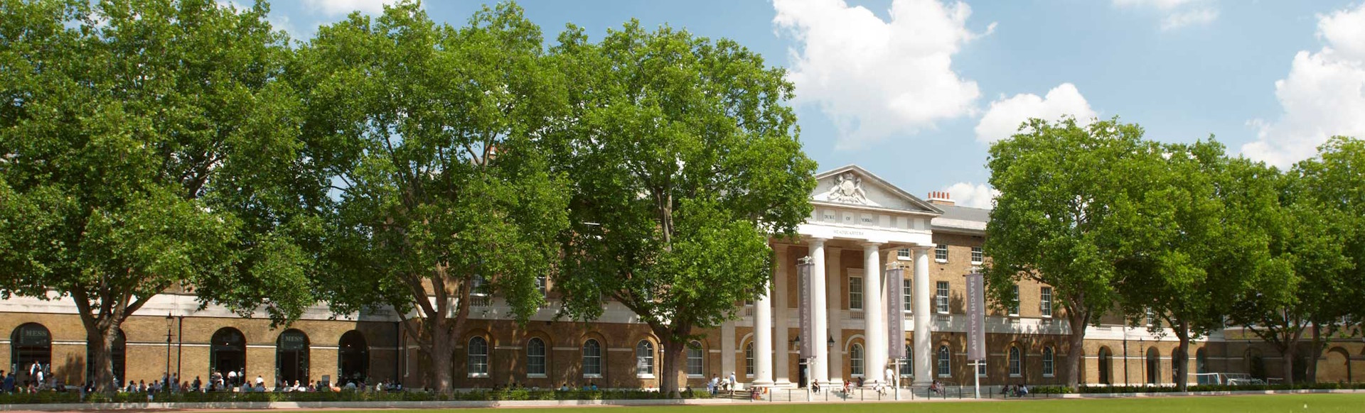A panoramic view of the Saatchi Gallery, with trees on either side.
