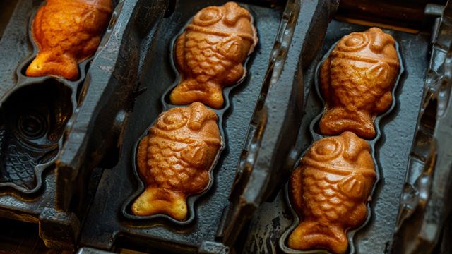 Black cast iron with mini Taiyaki moulds for making fish-shaped golden waffles, sold at Chinatown Bakery.