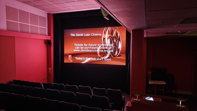 A screen inside a cinema that reads David Lean Cinema with red lighting.