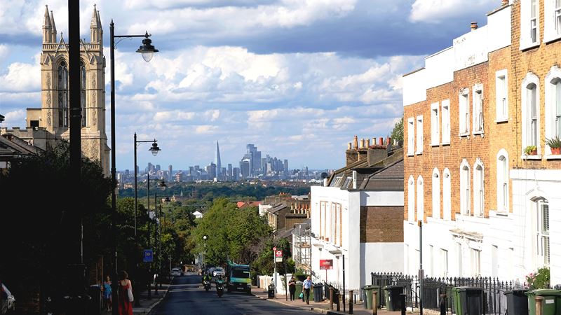 At the top of Westow Hill, a street lined with brick houses offers a panoramic view of London's skyscrapers in the distance.