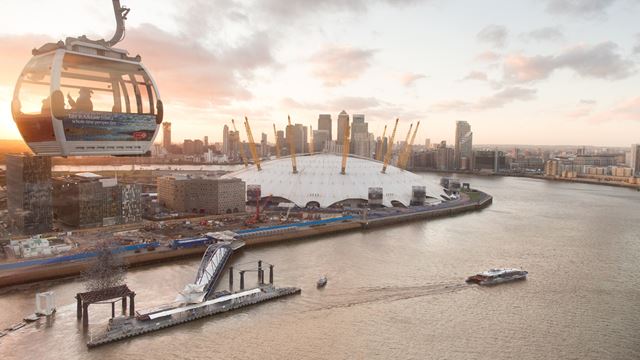 The sun sets in Greenwich over the Emirates Air Line cable car and The O2.