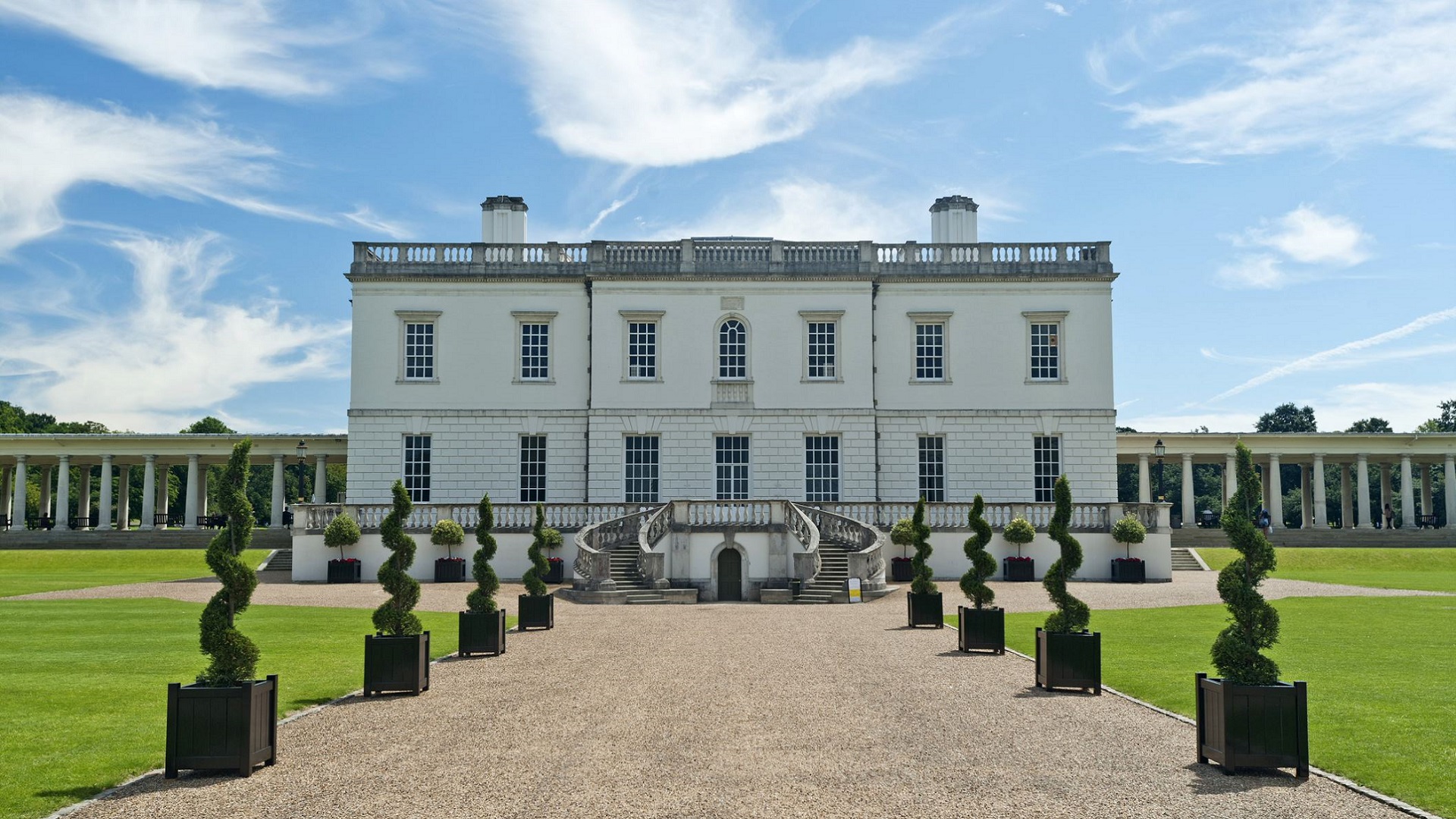 Topiary lines a gravel path to the Queen's House, a royal villa in Greenwich.
