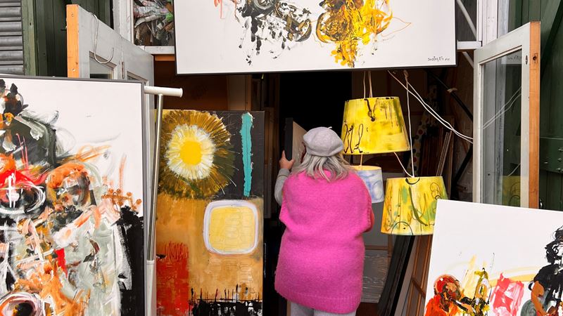 An artist surrounded by paintings in a studio on a road just behind Stoke Newington Church Street