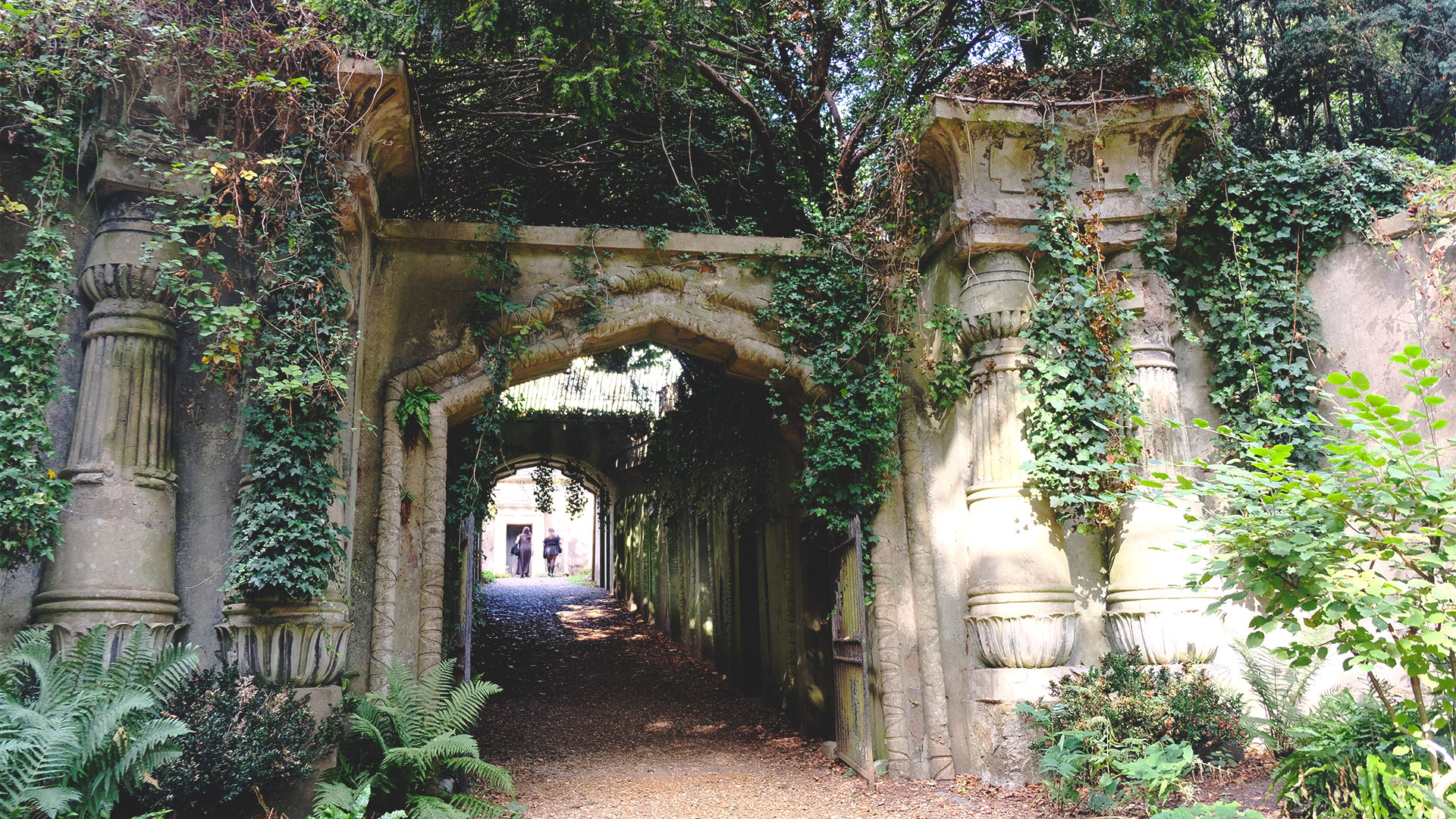 The entrance gate to the Egyptian Avenue, with its grand pillars, leads up to the Catacombs at Highgate Cemetery.