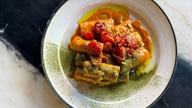 A photo of the tomato rigatoni pasta dish with a sprinkling of Japanese kosho at Osteria Angelina