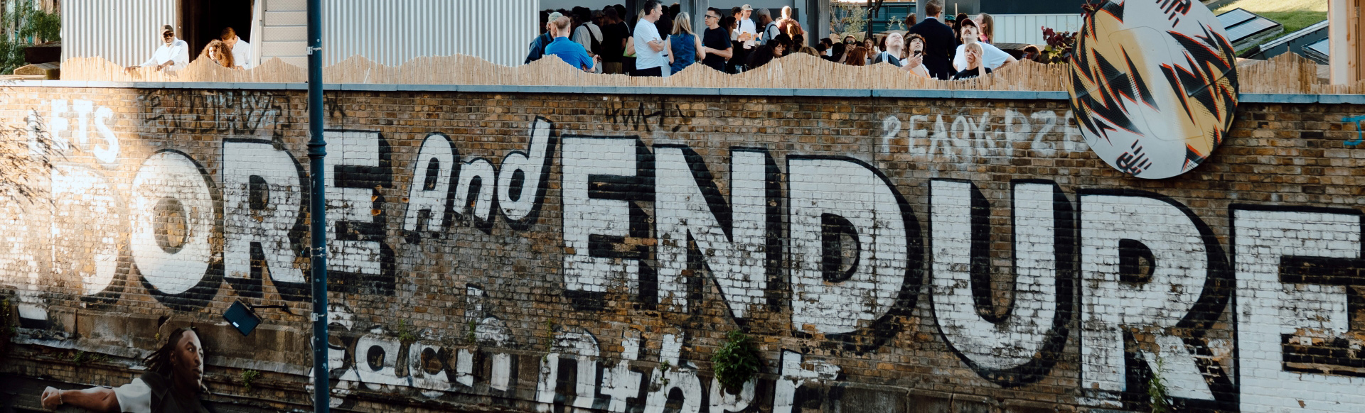 A photo of the famous street art facade in Shoreditch "Let's adore and endure each other"