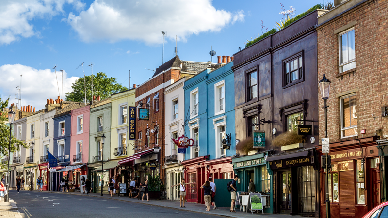 Colourful buildings along Portobello Road in Notting Hill, west London, on a sunny day.