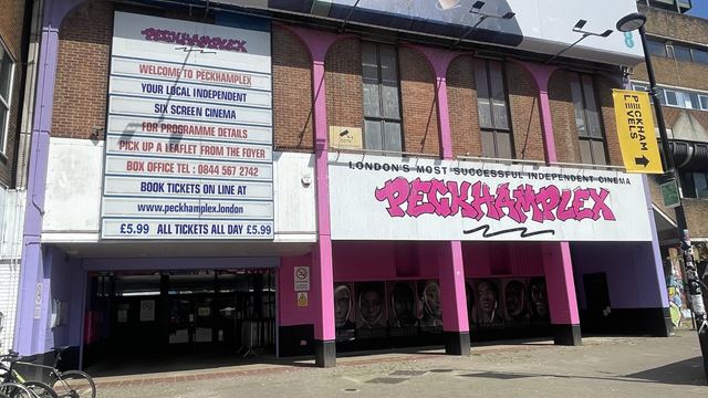 Peckhamplex cinema exterior including name in pink letters and a list of films showing at the cinema.
