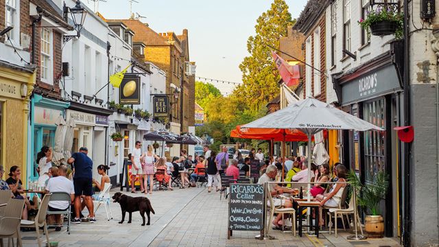 People dining and browsing independent shops along Church Street in Twickenham.