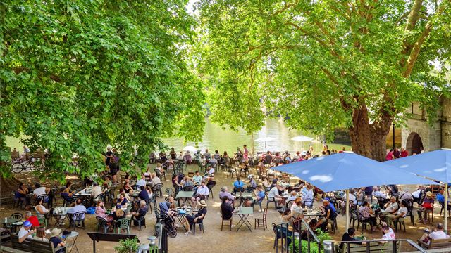 Outdoor seating at Tide Tables Cafe beside the river Thames in Richmond.
