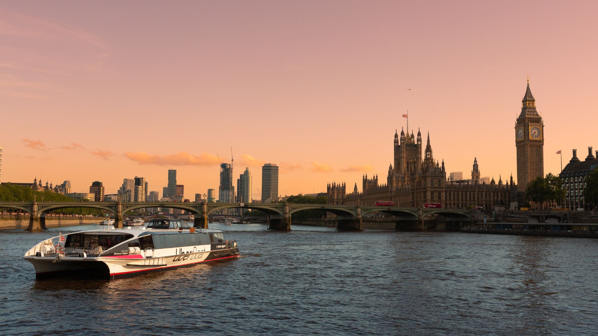 A view of Houses of Parliament and Big Ben from the river at sunset.