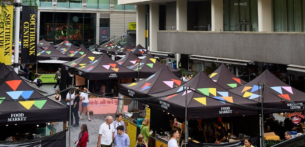 People walking around the tents at Southbank Centre Food Market.