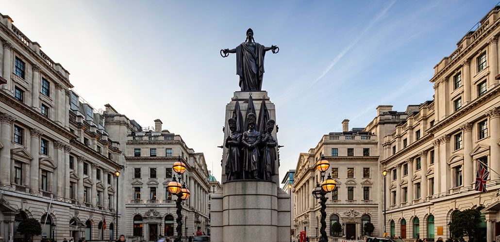 Looking along Waterloo Place on a clear day, with the Guards Crimean War Memorial in the foreground.