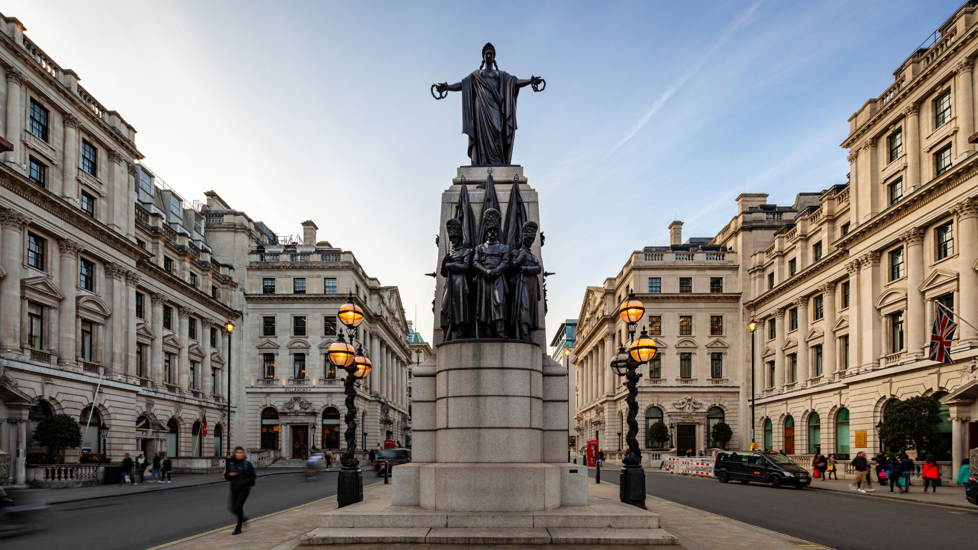Looking along Waterloo Place on a clear day, with the Guards Crimean War Memorial in the foreground.