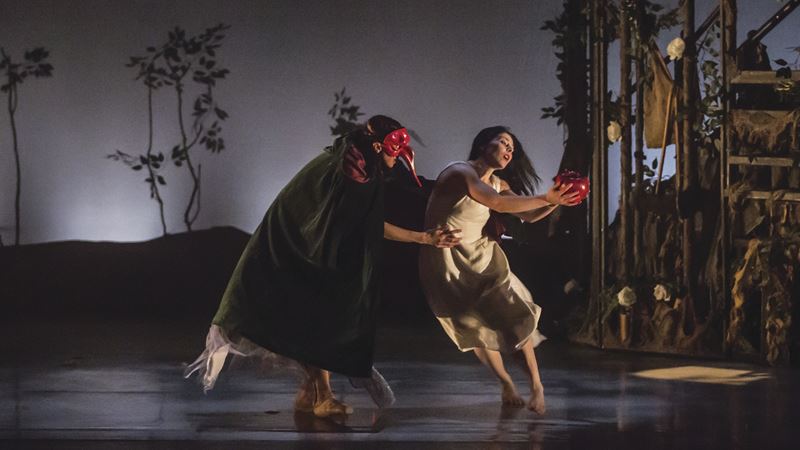 Past productions at Sadler's Wells East include Liv Lorent's Snow White. Credit: Lolo Penri. Image courtesy of Sadler's Wells East. Two female dancers, one dressed in black and wearing a red mask and another one in a white dress, performing Snow White on stage.