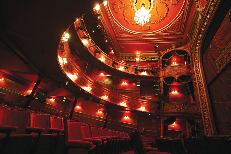See a show at Stratford East, a 460-seat theatre steeped in history. Credit: Stratford East. Image courtesy of Stratford East. Red seats and interior of Stratford East theatre.